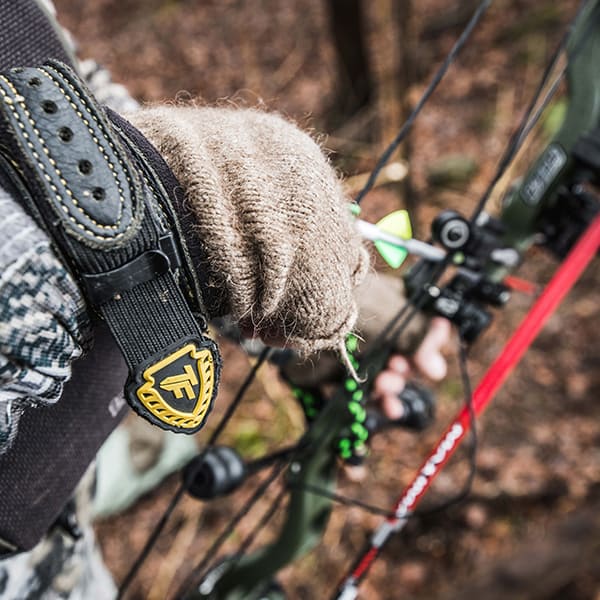 close up of hand on bow and arrow