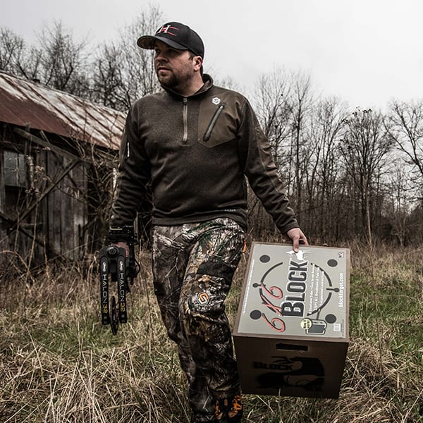 close up of person carrying a target block outside